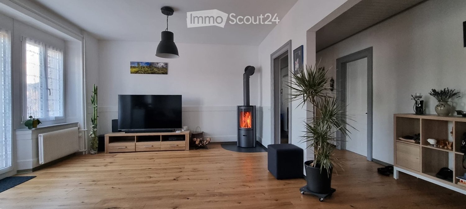 wooden floor, fireplace, flat screen TV, entertainment center, large windows, heater