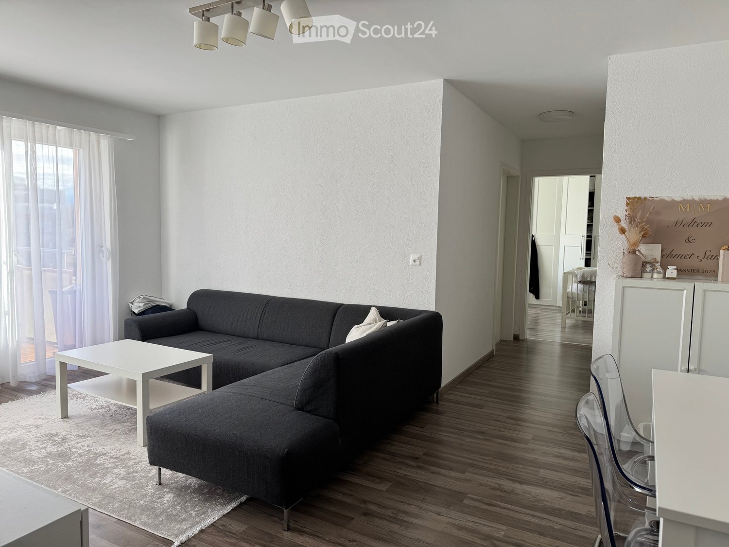 large sofa, coffee table, rug, side table, decorative plate, chairs