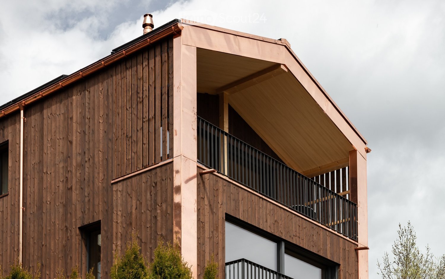 2 story wooden house, balcony, copper roof, black metal railing