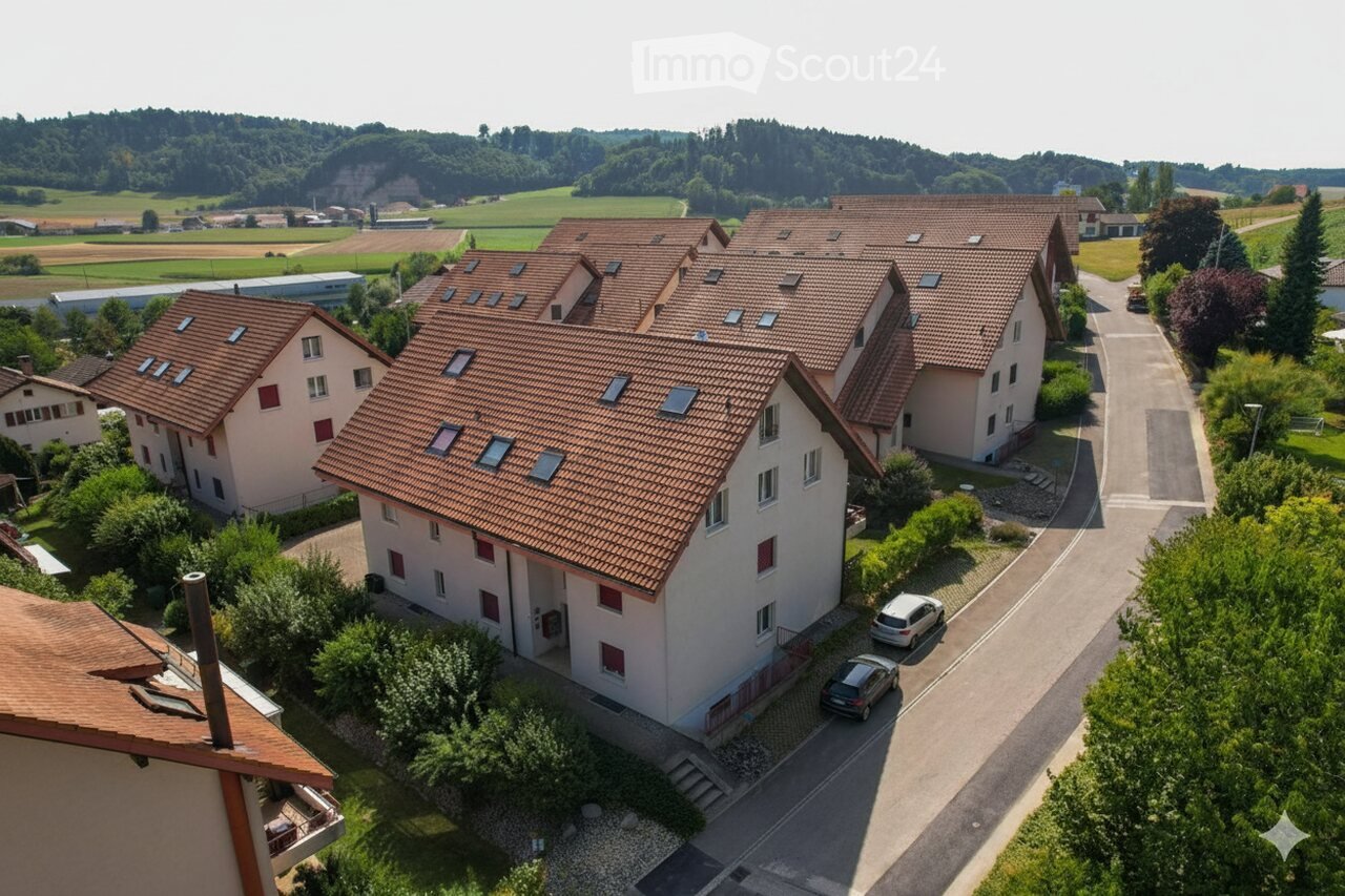 Aerial view of residential buildings, modern apartments, two cars parked