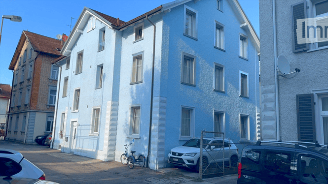 Three story blue house with 5 windows on each side