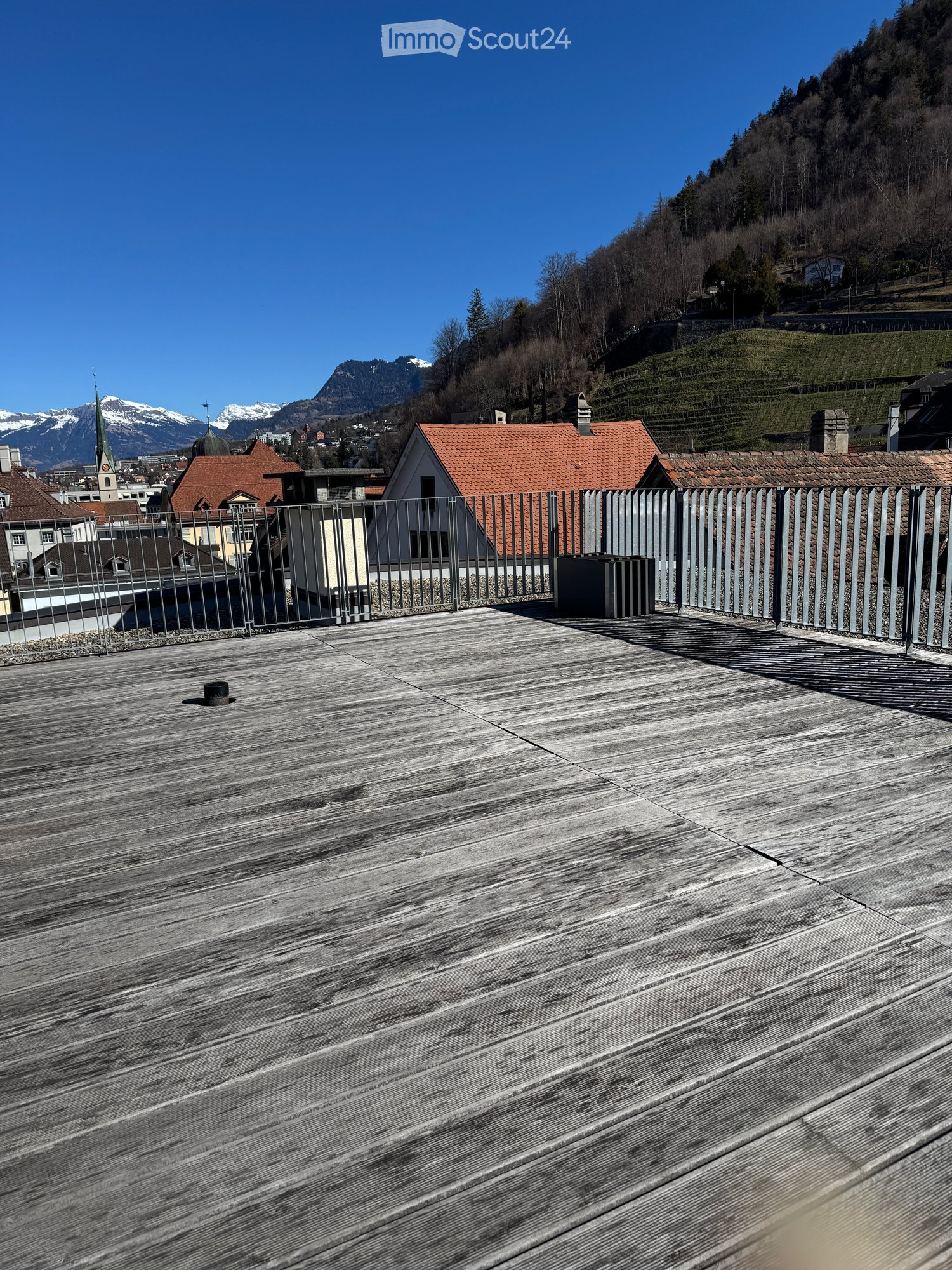 wooden flooring, steel railing, panoramic view of mountains, sky