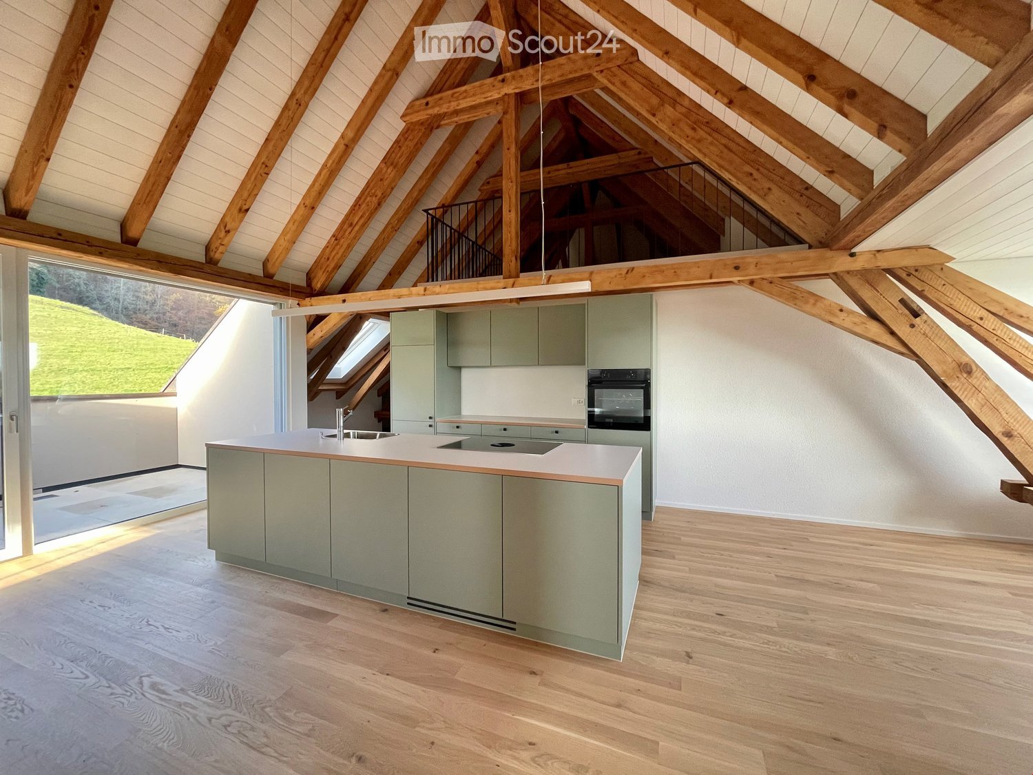 atrium-style room, kitchen island, wooden beams, glass sliding doors, sink, oven, and balcony