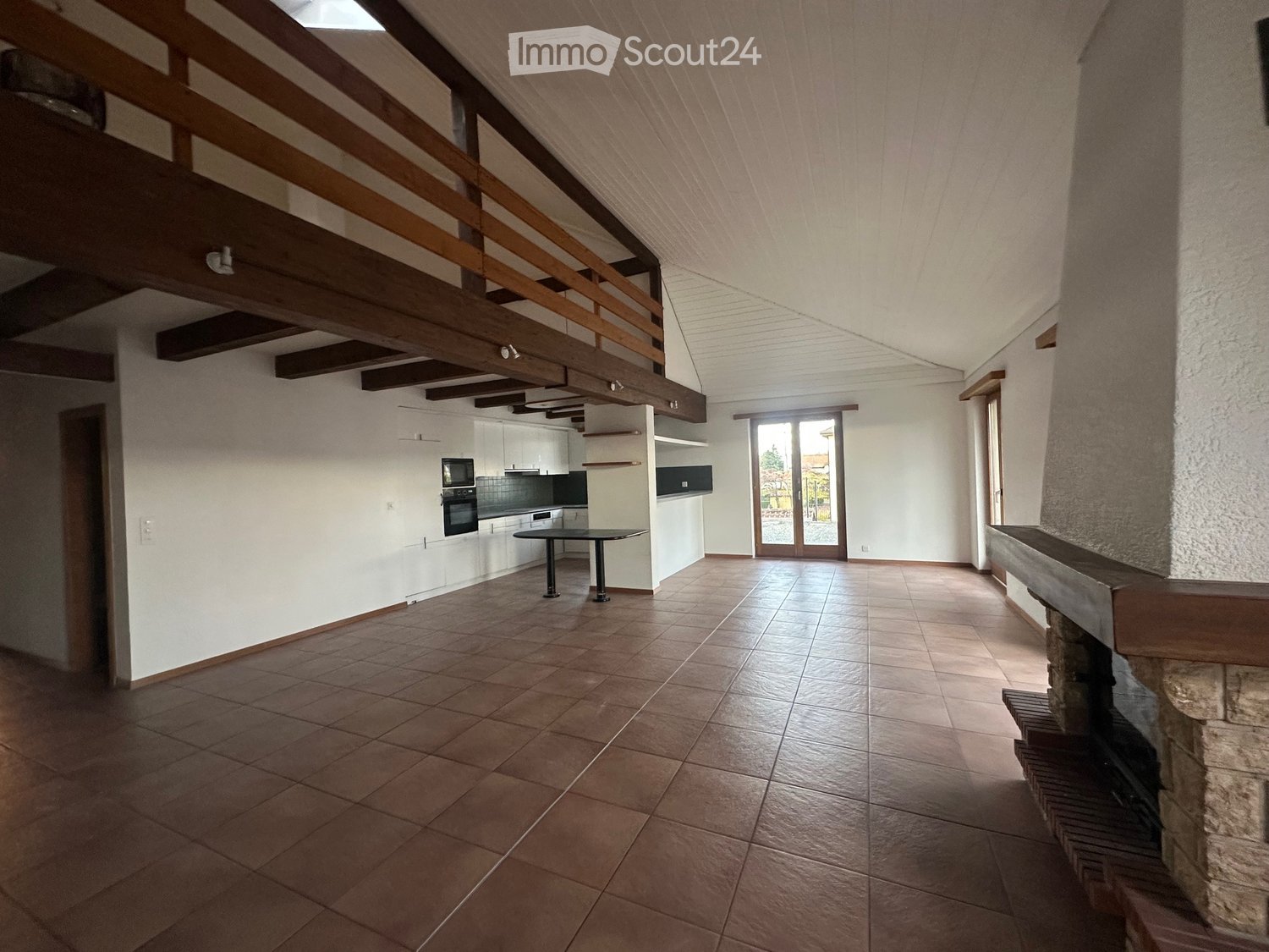 open space, modern design, brown tile flooring, fireplace, wooden balcony, kitchen area