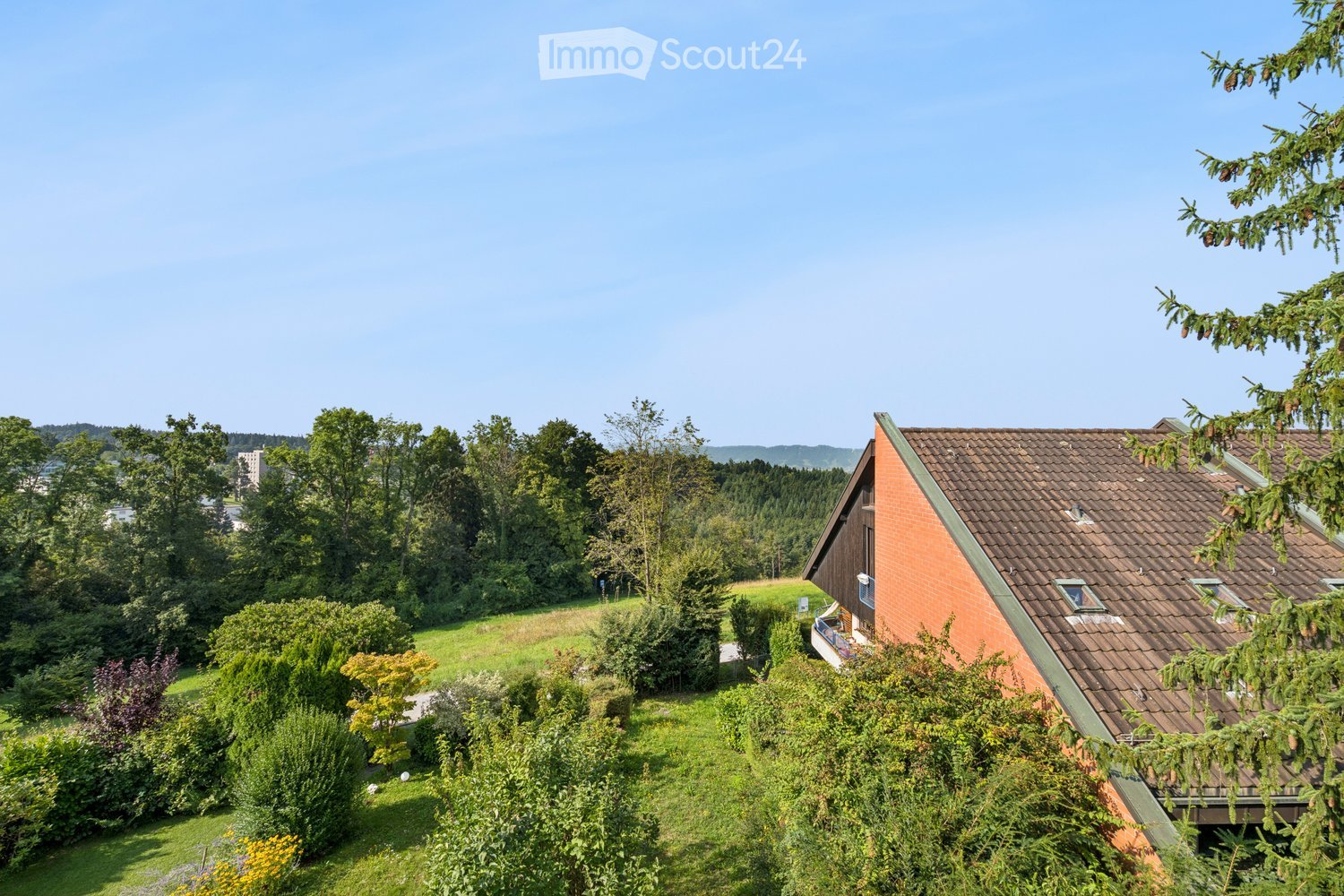 House on a hill, raised ground floor, surrounded by greenery