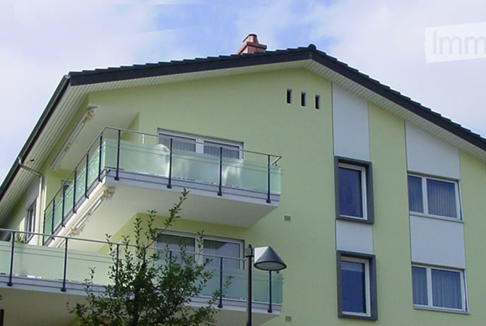 3 story house, yellow exterior, windows, balconies
