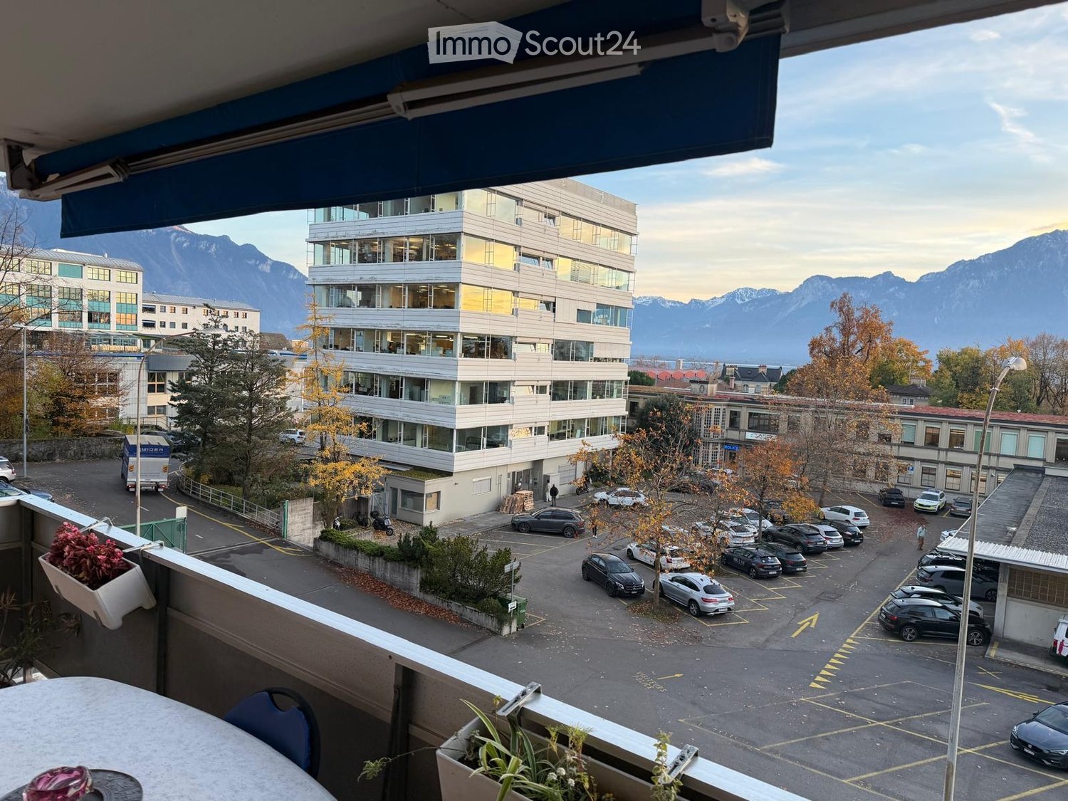 balcony with plants and view of parking lot and mountains