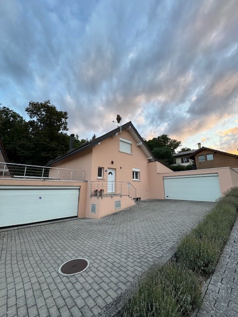 House with 2 garages in front, brick walls, brick driveway
