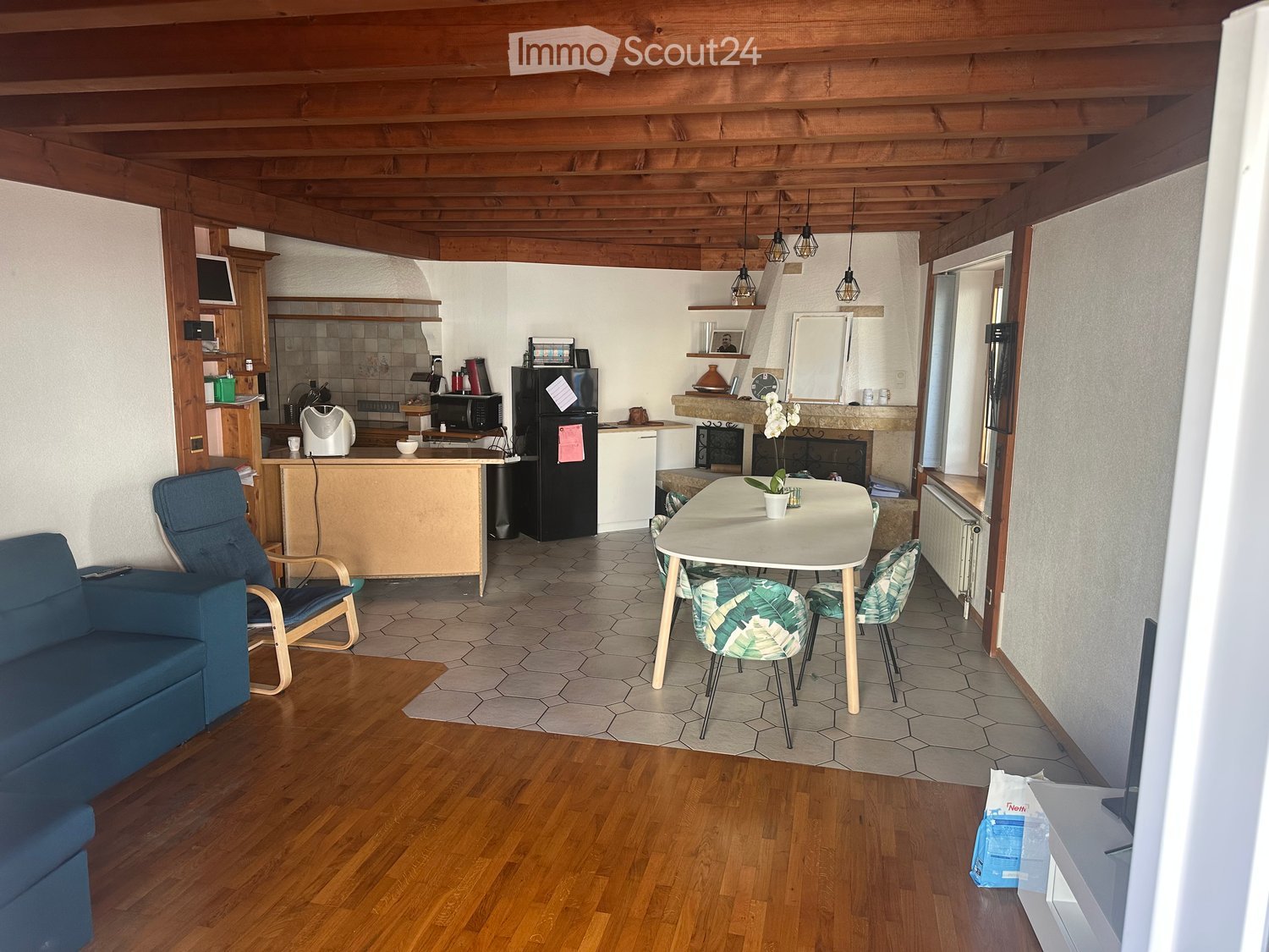 wooden ceiling, dining table with 6 chairs, sofa, open kitchen, fireplace