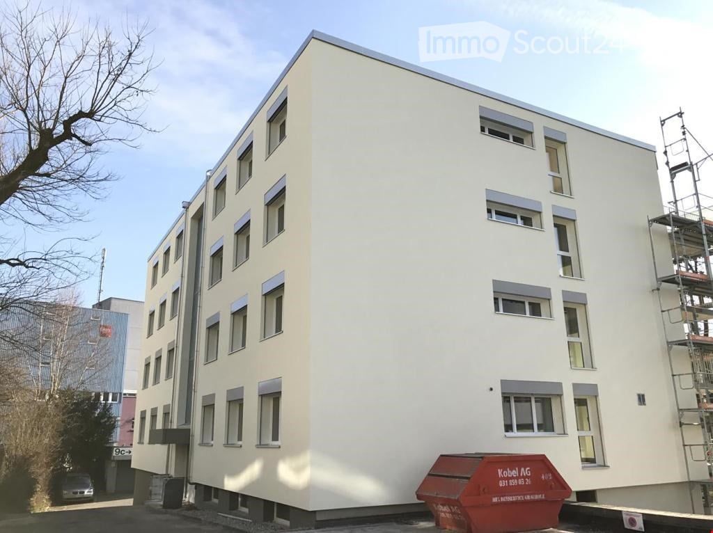 multistory apartment building, modern design, multiple windows, partially under construction