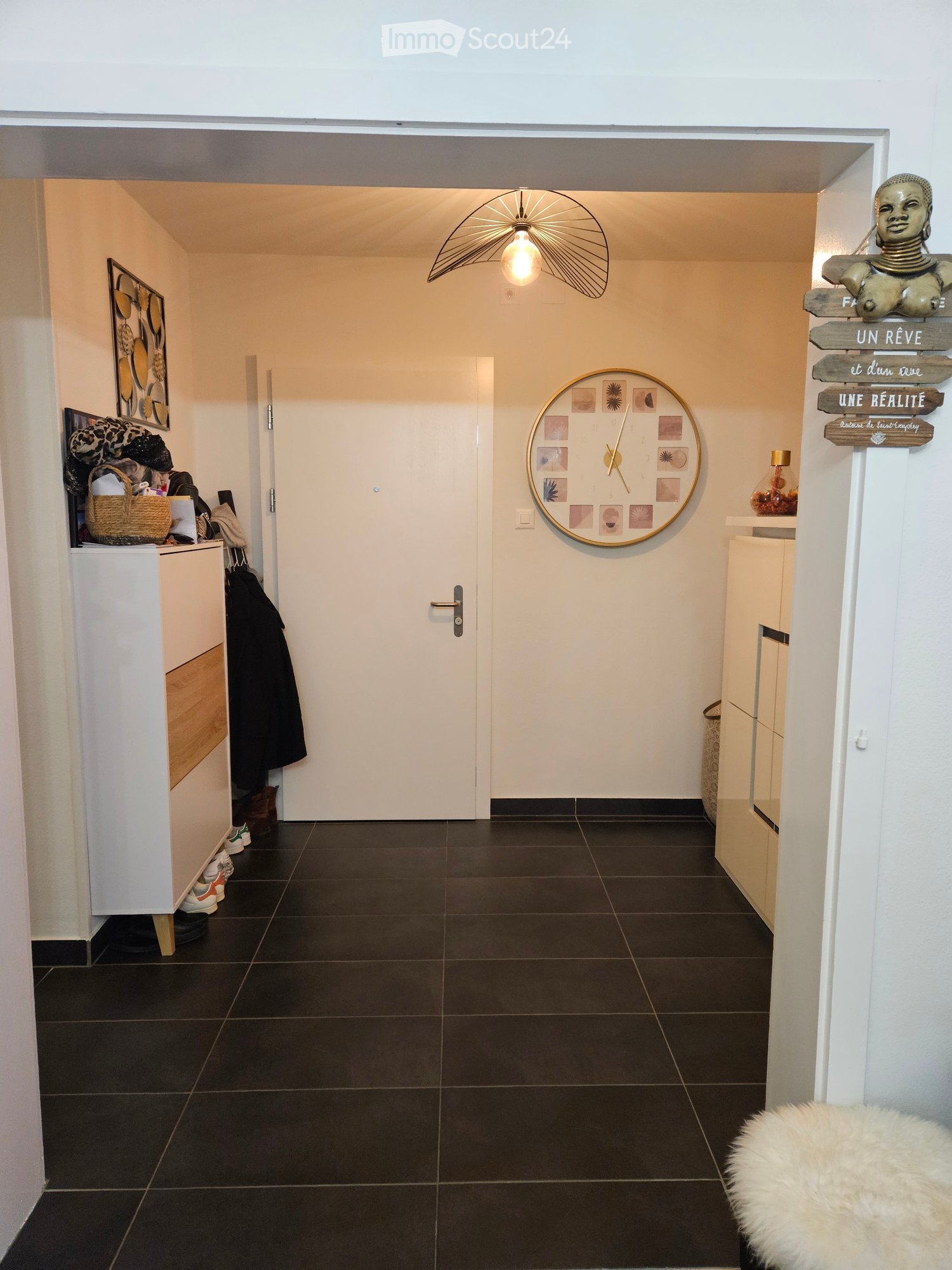white cabinets, light fixture, clock, black tiled floor
