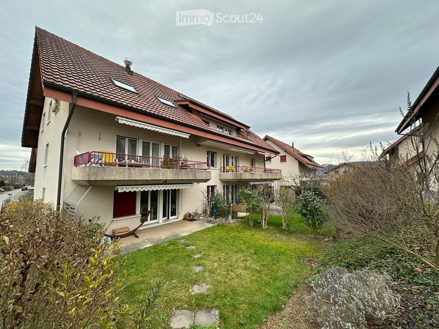2 story house, beige color, red roof, solar panels, balcony, garden