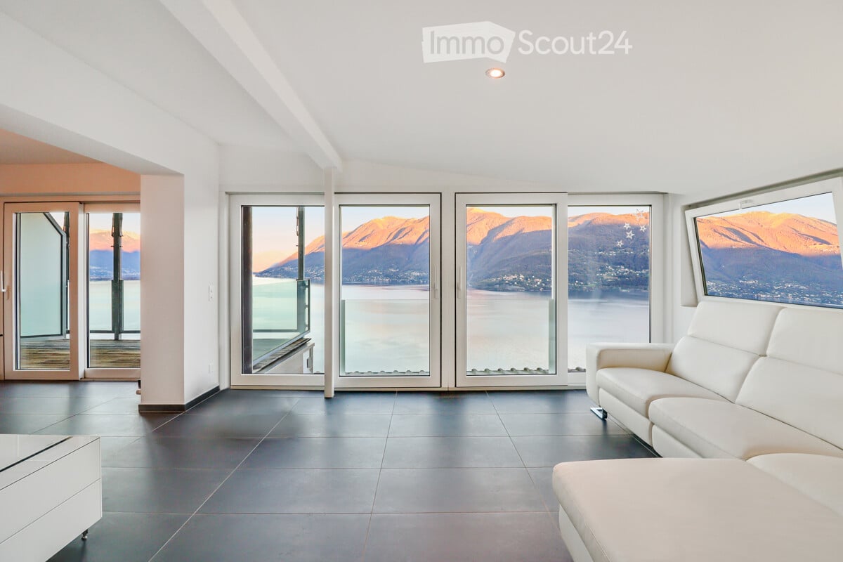 white couch, large windows, lake view, modern decor