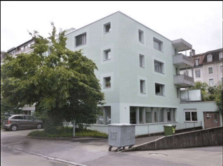 multi-storey residential building, balconies, car parked