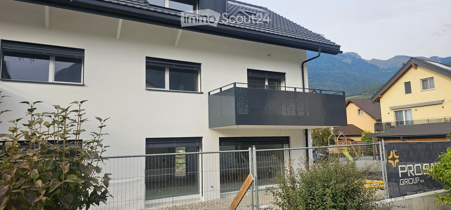 2 story house, white paint, gray roof, metal balcony, fence, garden