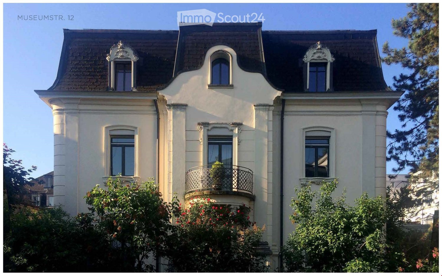 3-story house, white exterior, black roof, multiple windows, balcony with railings