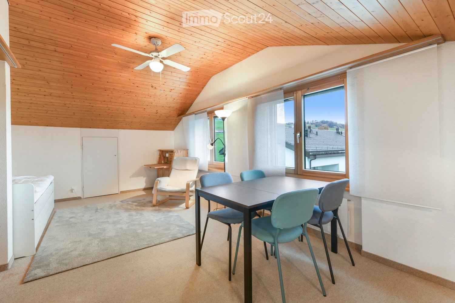 Dining room with table, chairs, lamp, couch, and bed