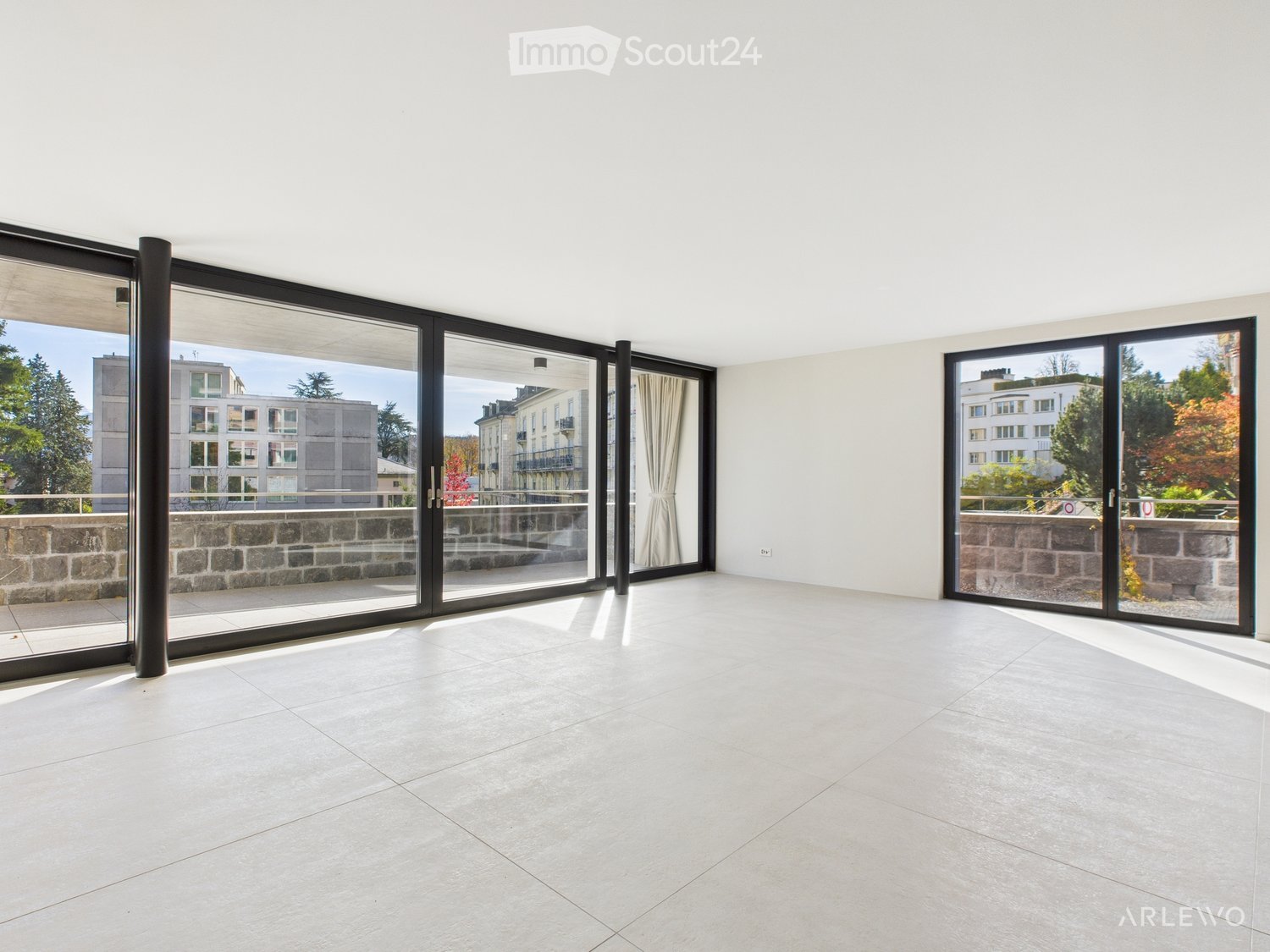large glass windows, balcony, large open space, large white tiles