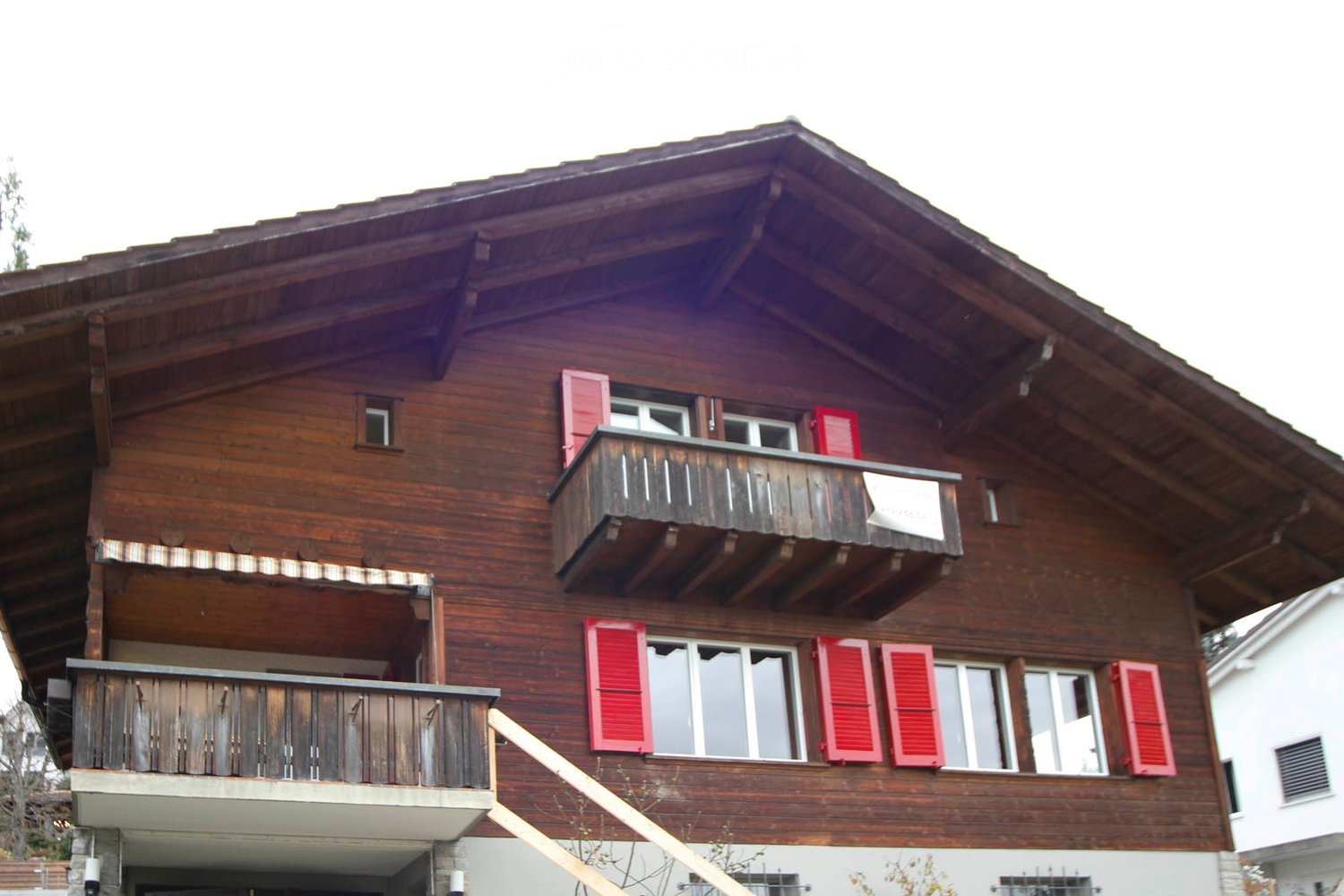 Wooden chalet house, 2 storeys, red shutters, balconies