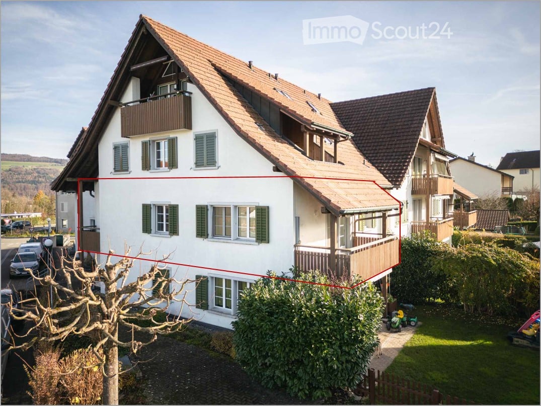 White house, brown roof, green window shutters, two stories, raised ground floor, terrace on first floor, garden, fenced
