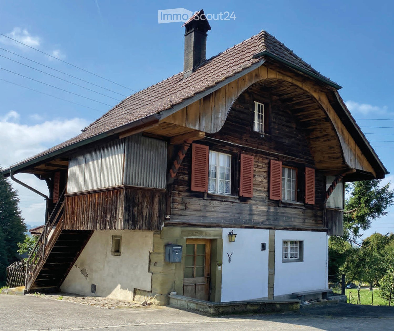 wooden house, tiled roof, red shutters, raised ground floor, wooden stairs, chimney