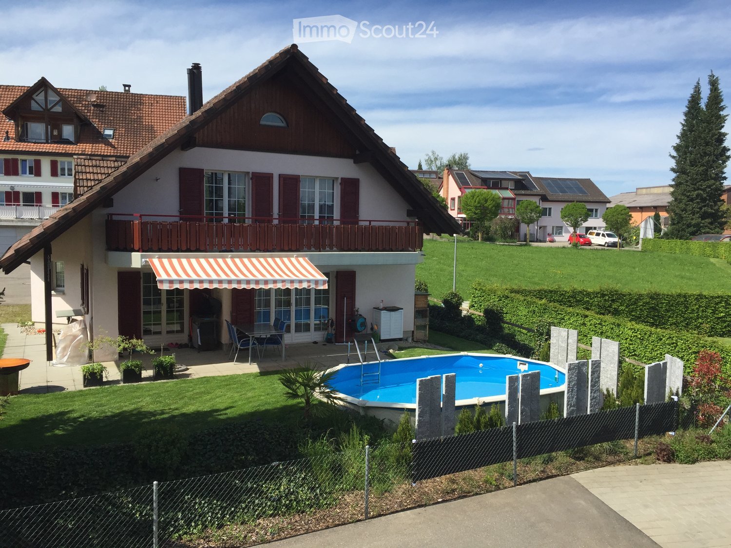 2 story house, brown roof, white walls, brown shutters, terrace, swimming pool