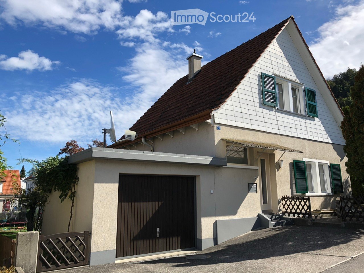 Detached house, brown roof, white walls, green shutters, chimney, garage