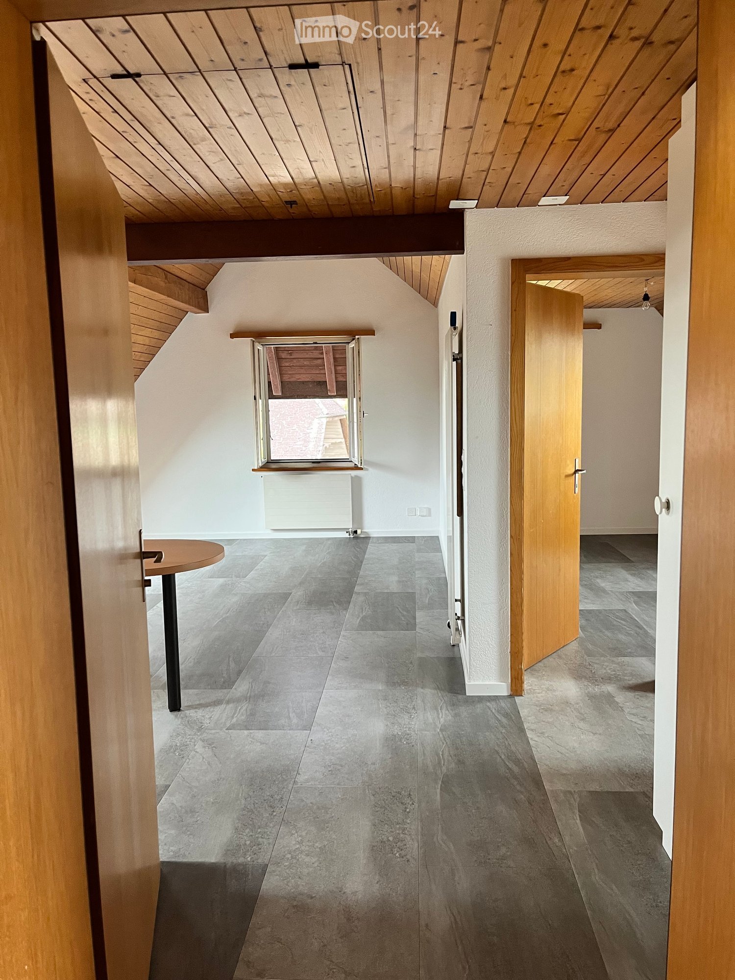 room, hardwood flooring, wooden ceiling, window, white walls, table