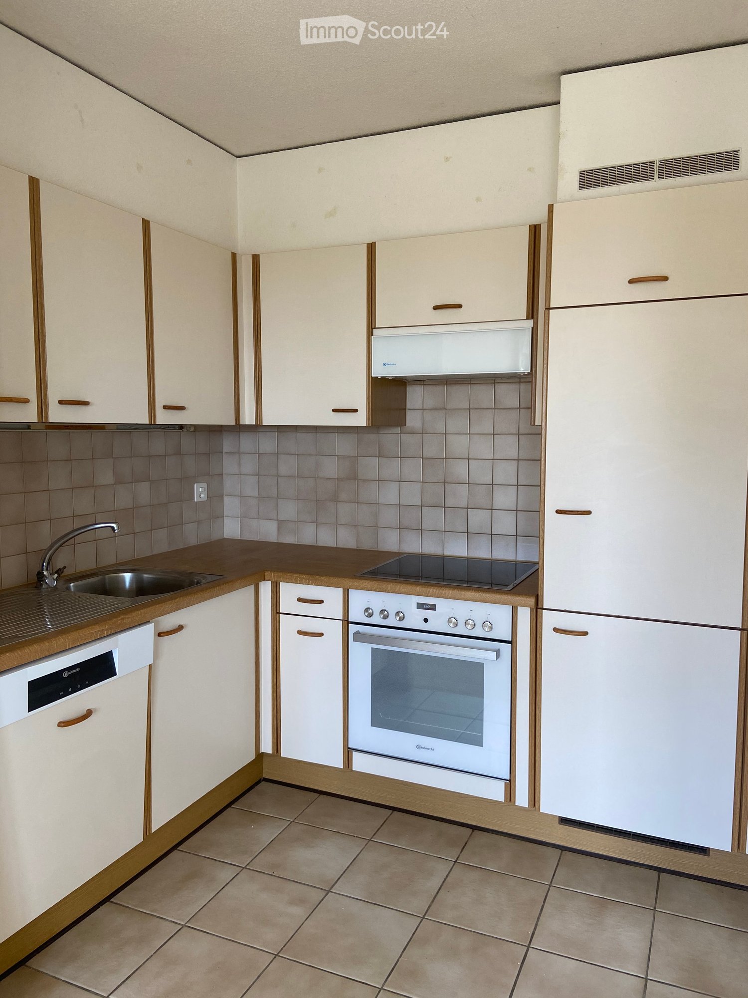 Tiled floor, White cabinets, Oven, Dishwasher, Sink, Tiled backsplash