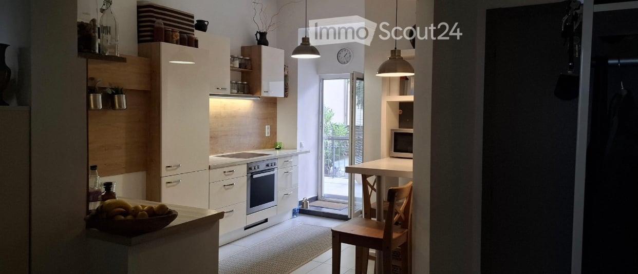 modern white kitchen, wooden cabinets, granite countertops, appliances, glass door leading to balcony