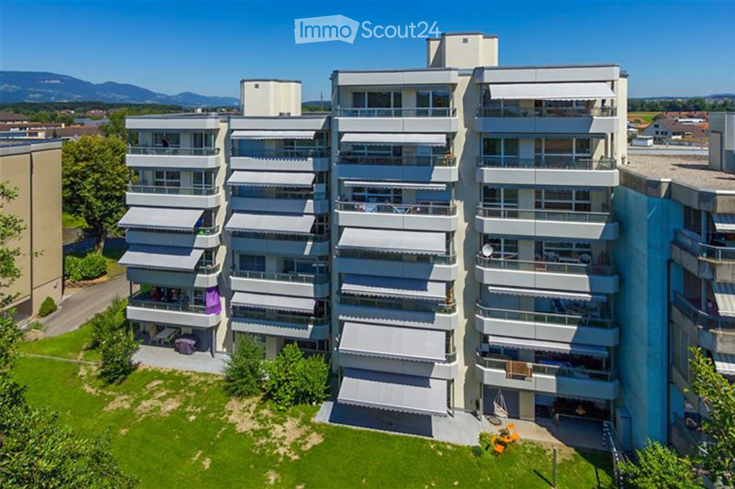 A high-rise building with multiple balconies and covered terraces.