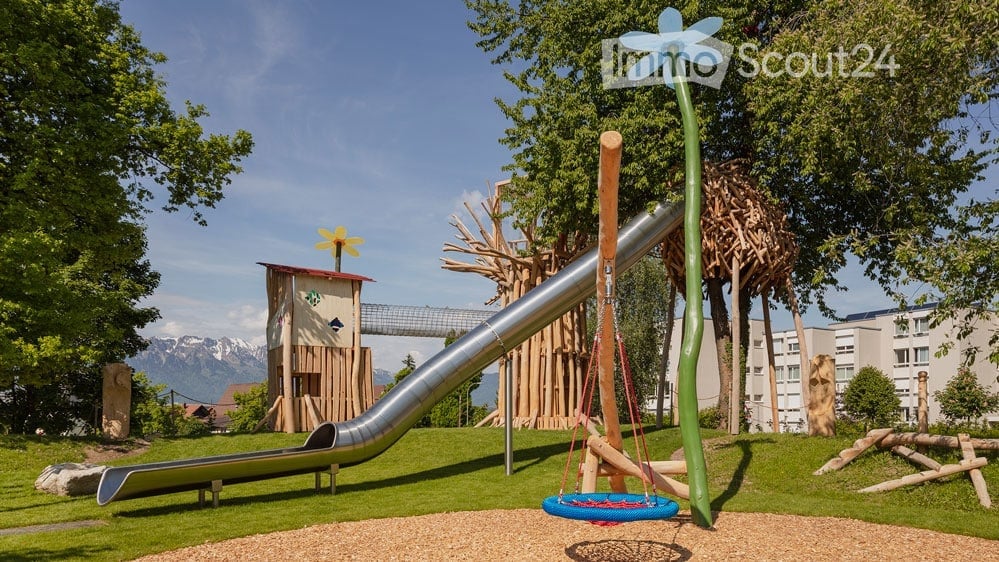 Metal slide, tire swing, flower shaped tree