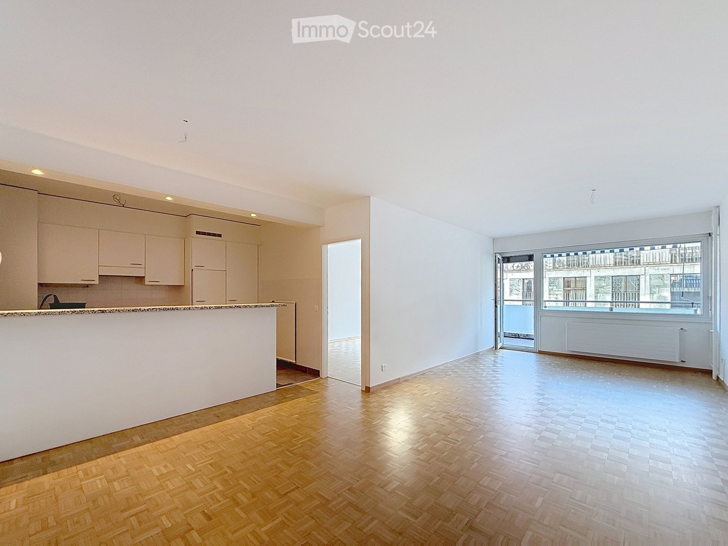 modern, empty kitchen, white cupboards, island, tiled floors, large windows, view