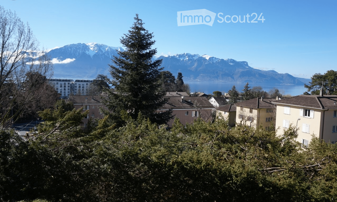 Buildings with view of a lake and mountains in the distance