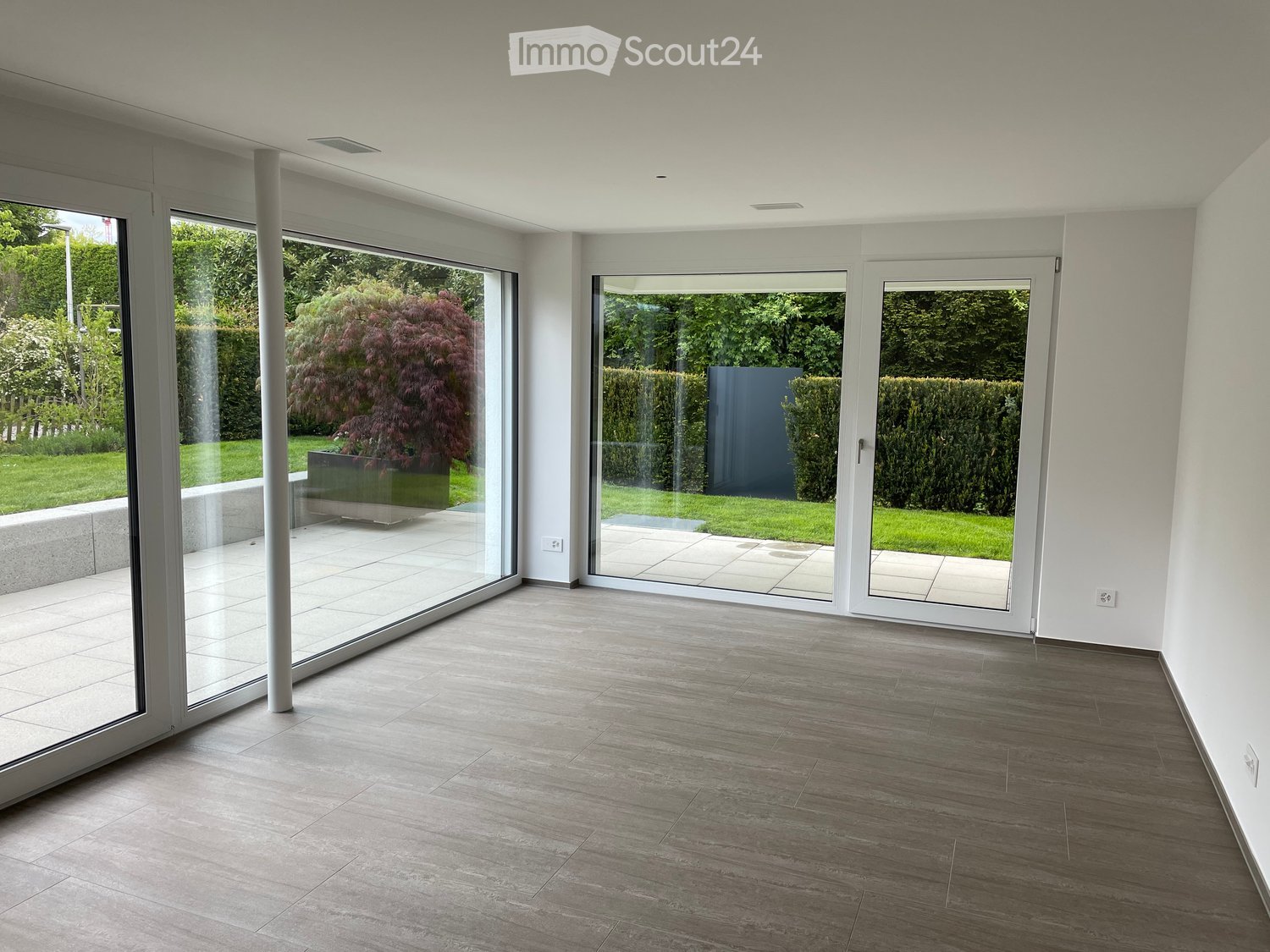 large glass doors, sliding doors, patio, view of outdoor garden, tile flooring, light walls