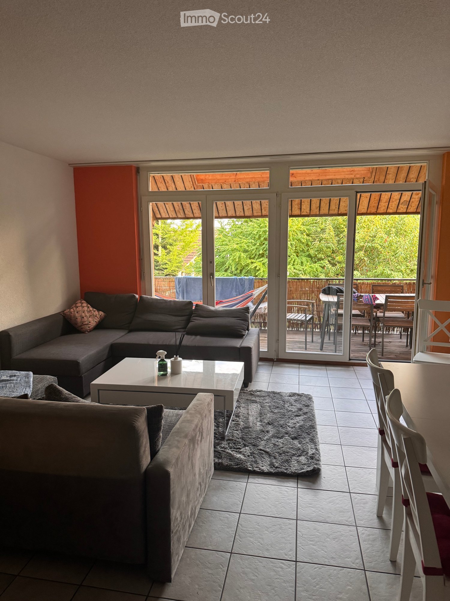 2 sofas, coffee table, rug, sliding glass doors, balcony, dining area with table and chairs