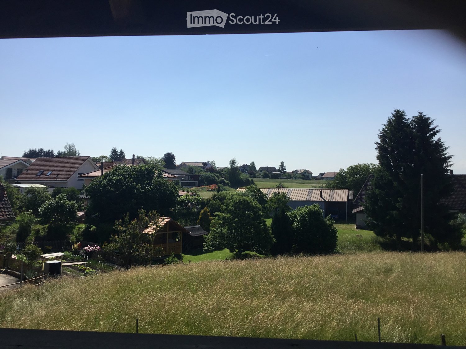 Countryside view with houses, trees, and a field