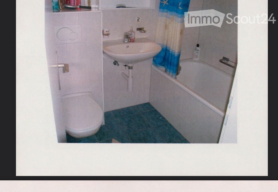 white toilet, white sink, bathtub, blue tiles