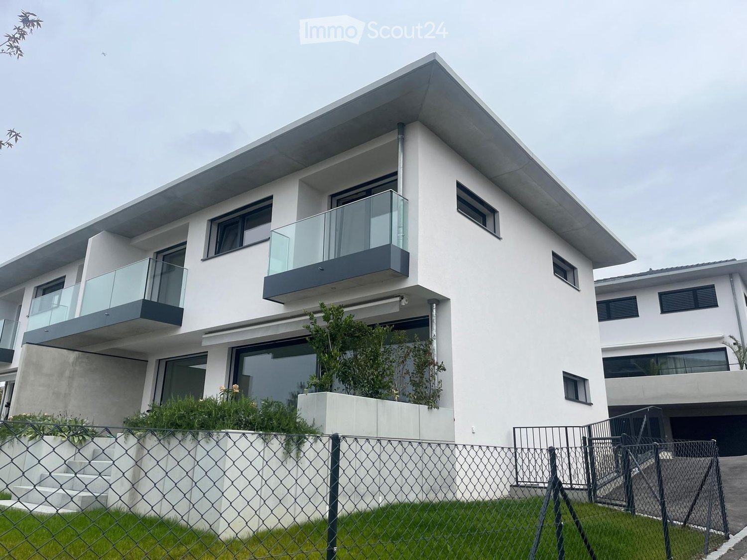 modern, white, two story house, glass balconies, fenced garden, staircases