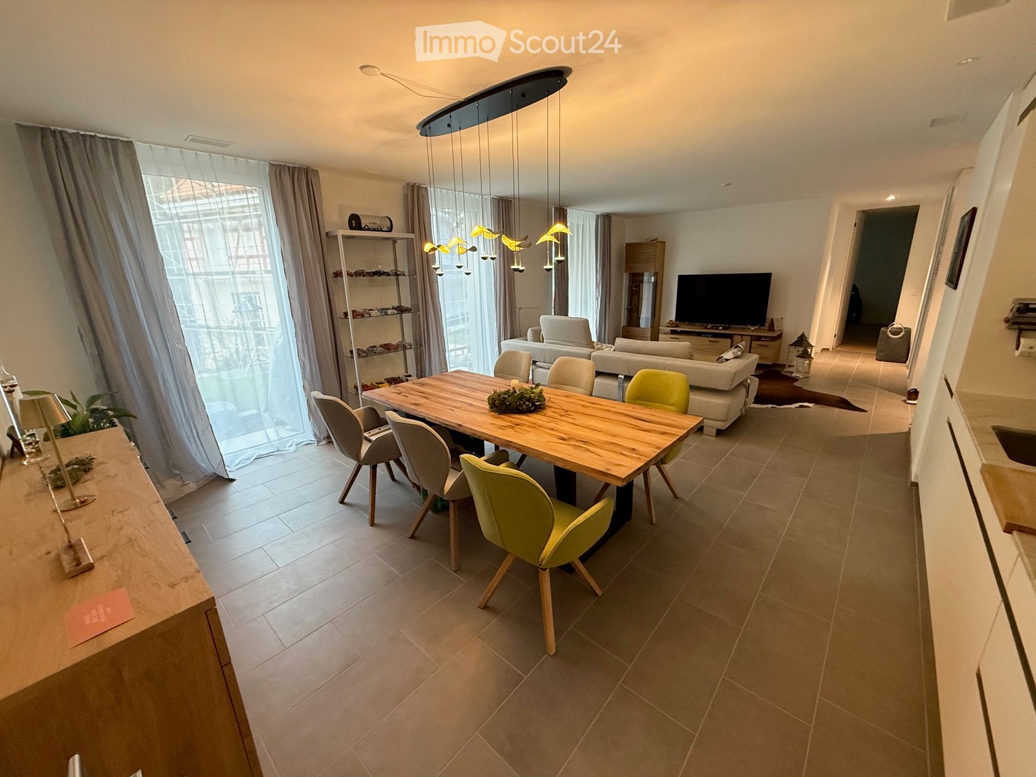 modern dining room, large wooden dining table, large windows, modern sofa, large curtains