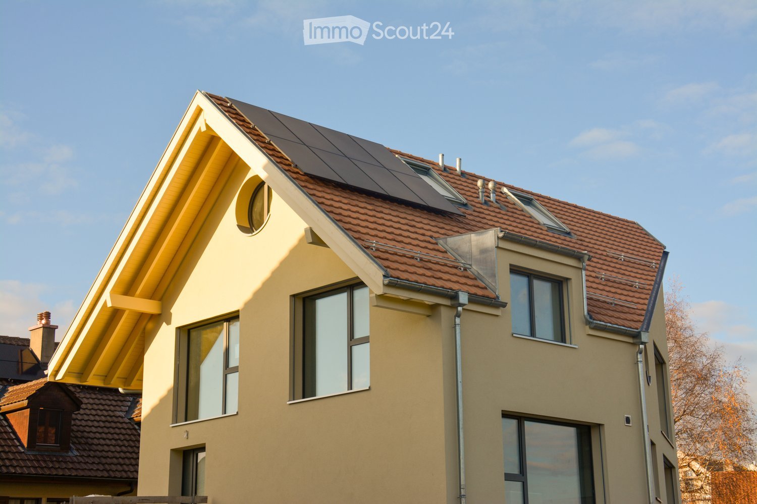 yellow exterior, solar panels on the roof, dormer windows, gutters, double-pane windows
