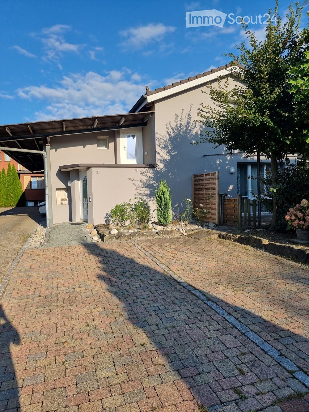 single family house, driveway, grey walls, brown roof, green shrubs, front garden
