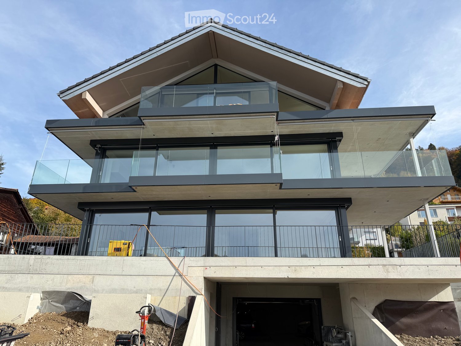 3-story house, glass walls, balcony, raised ground floor, garage, glass railing
