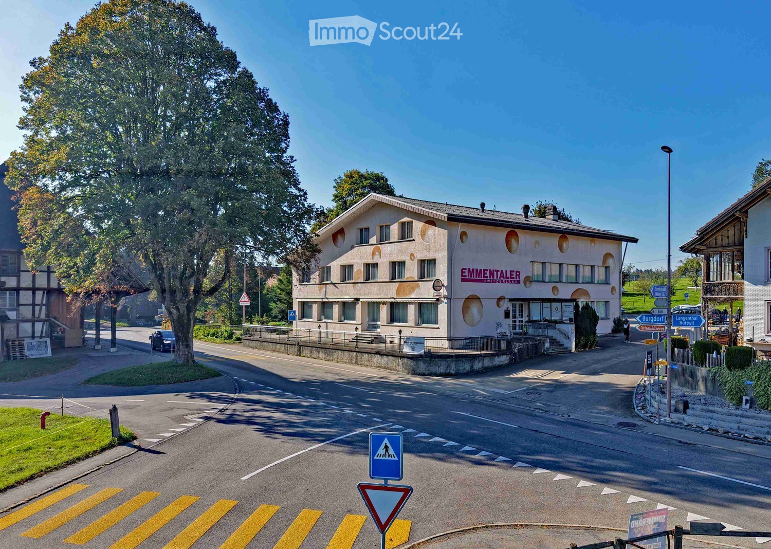white building, circular windows, sign reading 'EMMENTALER STEIERTRAKTOR'