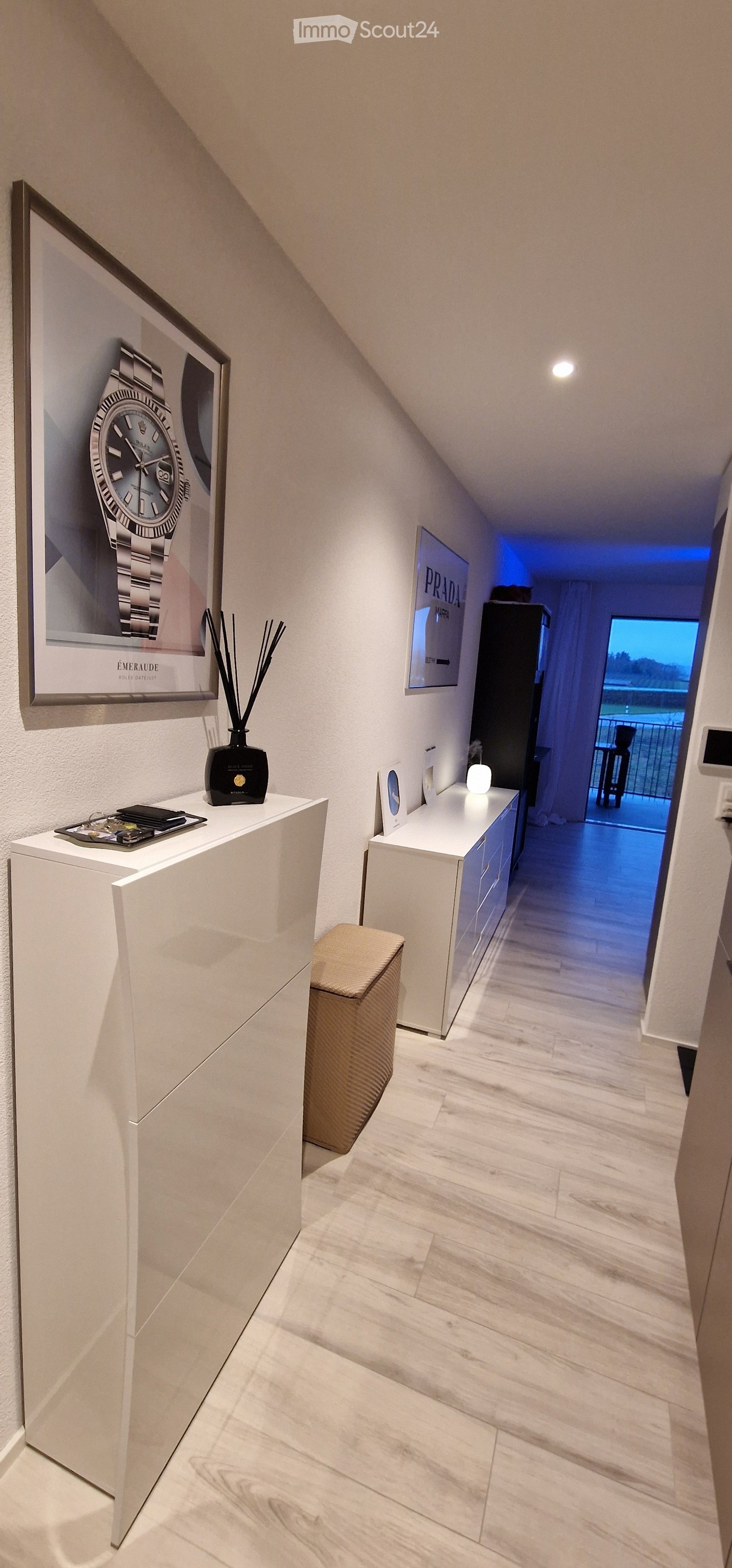 White furniture, tiled floor, framed picture, balcony access