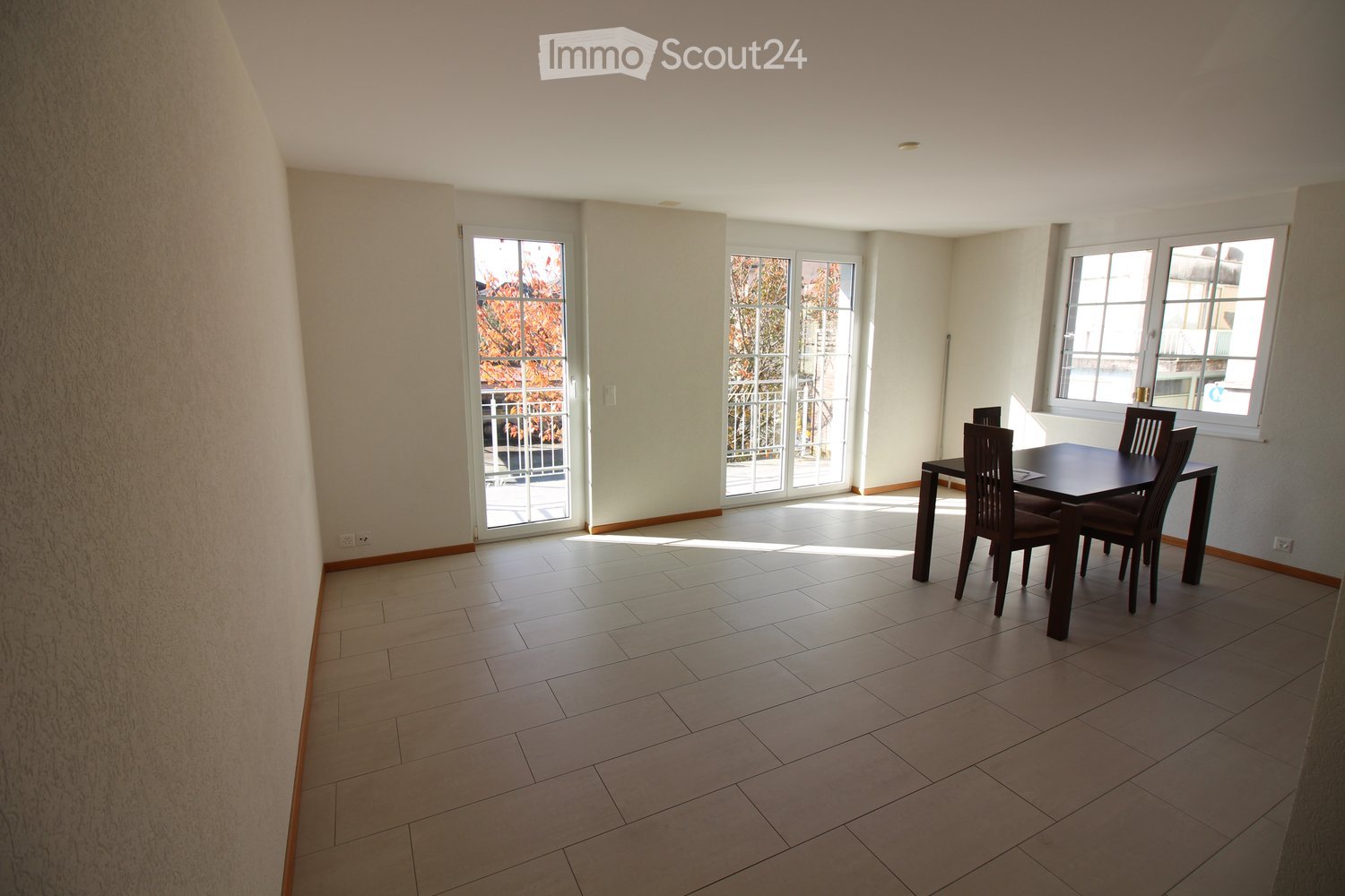 dining room, white tile flooring, sliding glass doors, table and chairs, light walls, large windows