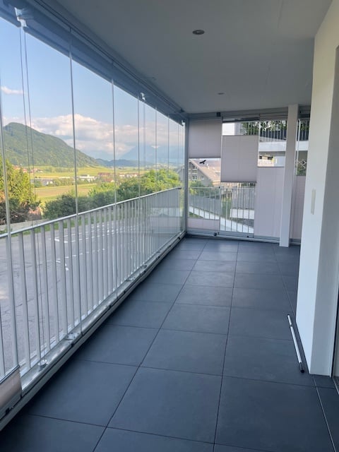 balcony, large glass walls, view of mountains