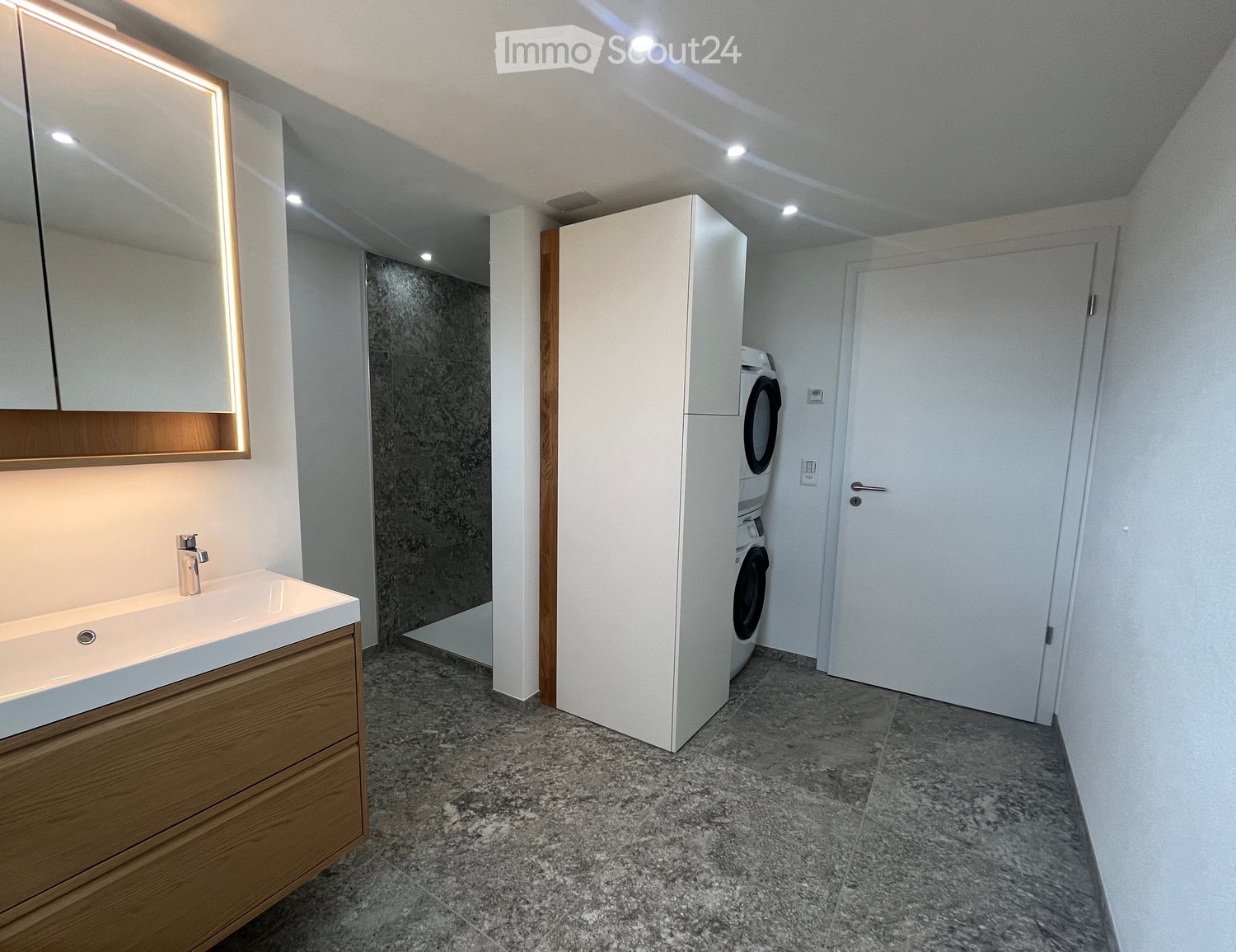 modern bathroom, white tiles, wooden cabinet, white sink, shower, washing machine