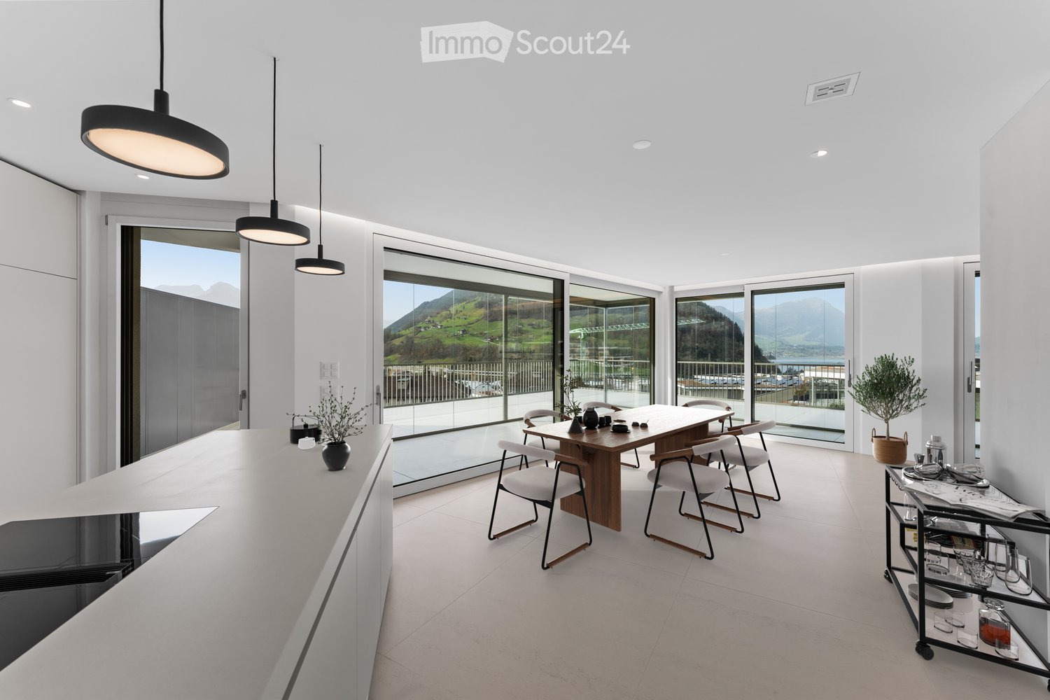 modern kitchen with wooden dining table, large windows, balcony, white cabinets, modern lighting, minimalist decor
