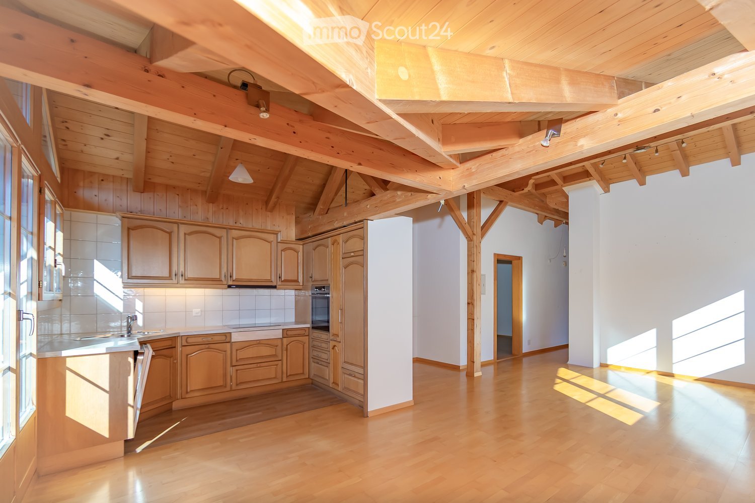 modern kitchen with wooden cabinets, sink, oven, windows, wooden floor, wooden beams